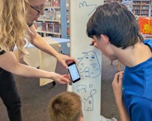 Collaborative mural with a group of year 9s, helping them re-design the Young Adult area of Loughborough Library. We ran a series of workshops and reshaped the student artwork into scene which we coached them to help install. Amanda Rigby