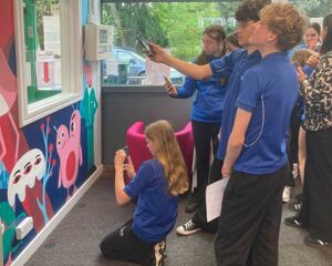 Previewing Augmented reality animations. Collaborative mural with a group of year 9s, helping them re-design the Young Adult area of Loughborough Library. We ran a series of workshops and reshaped the student artwork into scene which we coached them to help install. Amanda Rigby